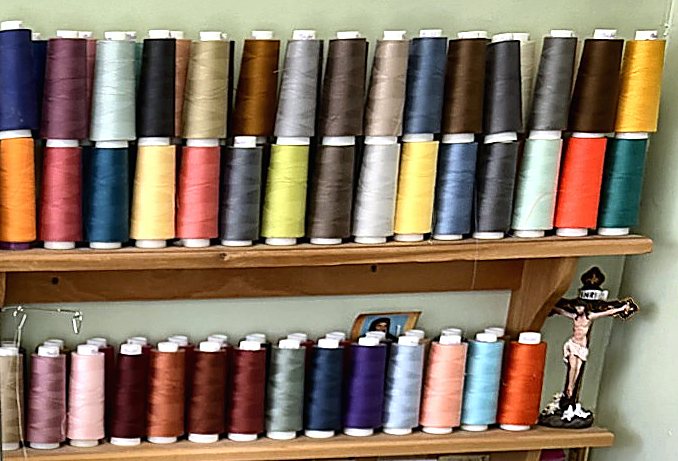Shelves stocked with spools of thread in dozens of colors
